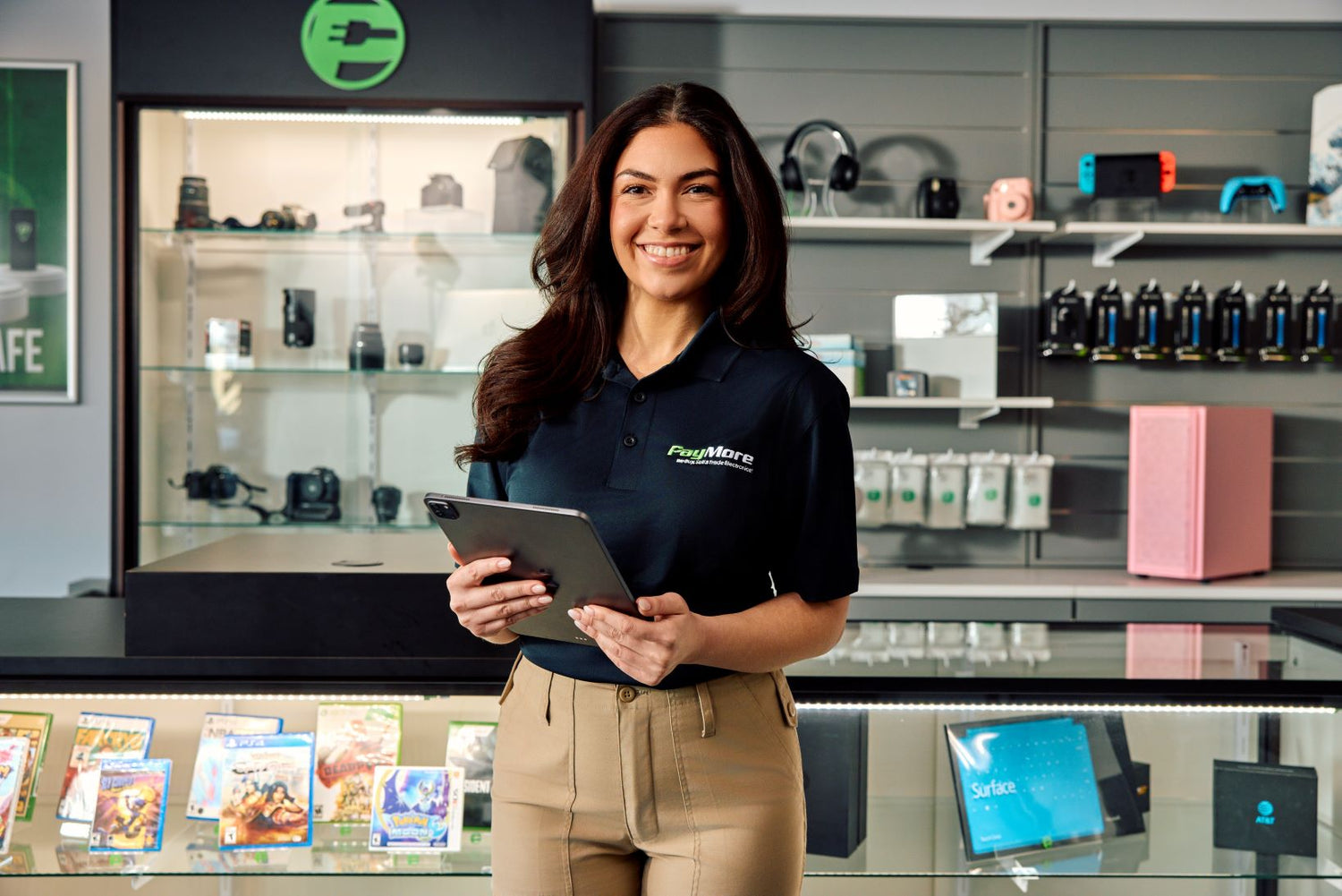 paymore employee holding a tablet and smiling